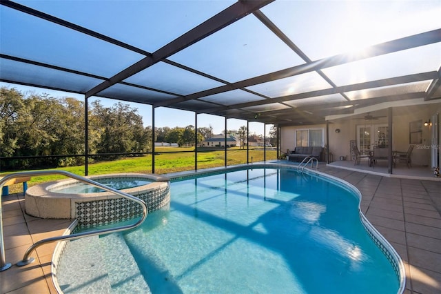 view of pool featuring an in ground hot tub, a yard, glass enclosure, and a patio