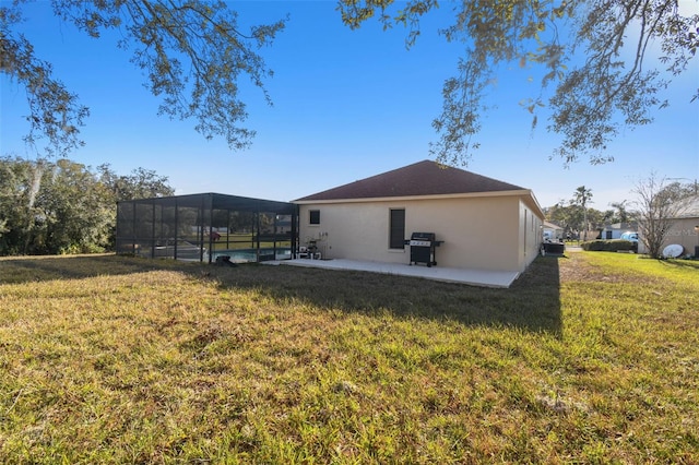 back of property featuring a pool, a lanai, a patio area, and a lawn