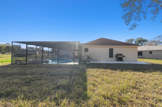 rear view of house with a yard, a lanai, and a patio