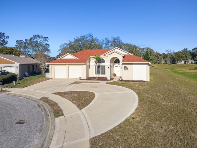 mediterranean / spanish house with a garage and a front lawn