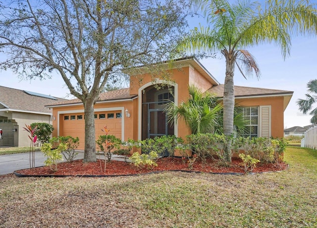 view of front of home with a garage and a front yard