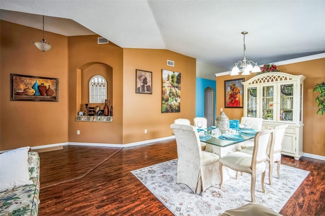 dining room with dark hardwood / wood-style flooring, a notable chandelier, and vaulted ceiling