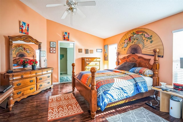 bedroom featuring dark hardwood / wood-style flooring, multiple windows, vaulted ceiling, and ceiling fan