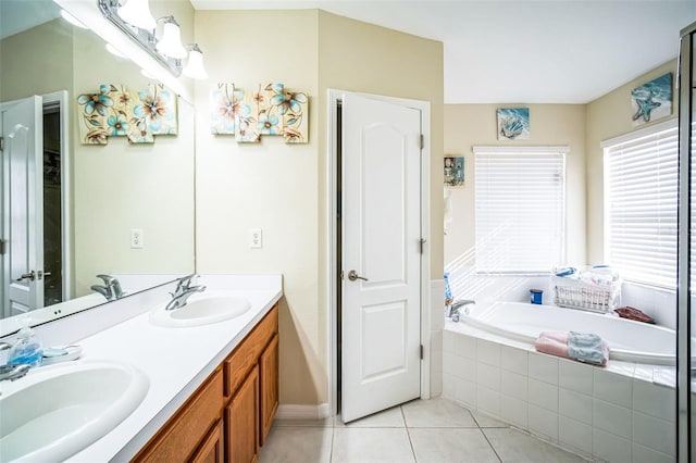 bathroom featuring vanity, a relaxing tiled tub, and tile patterned floors