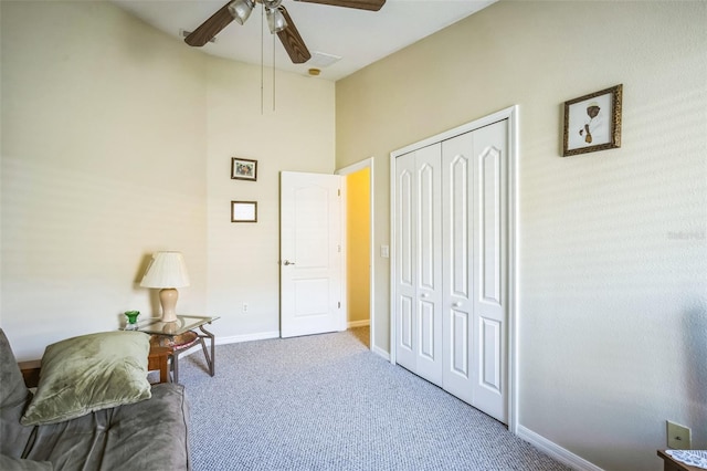 living area featuring ceiling fan and carpet floors