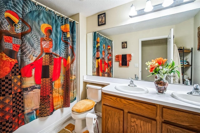 full bathroom with shower / bath combination with curtain, vanity, toilet, and a textured ceiling