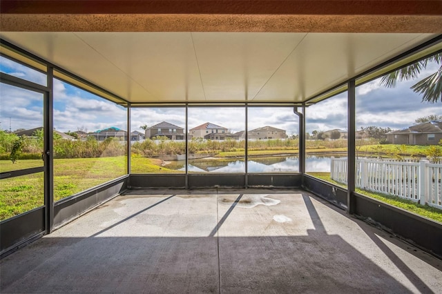 unfurnished sunroom with a water view and a wealth of natural light