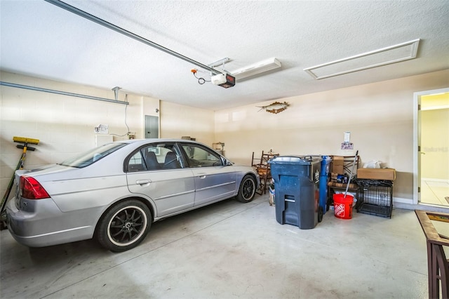 garage with a garage door opener and electric panel