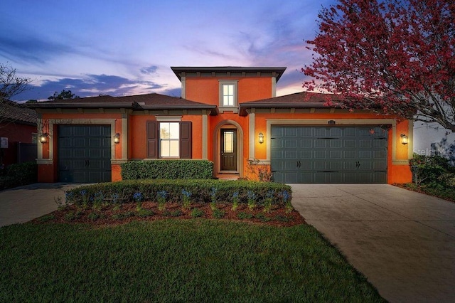 prairie-style home with a yard and a garage