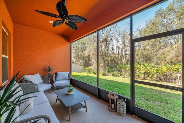 unfurnished sunroom with ceiling fan