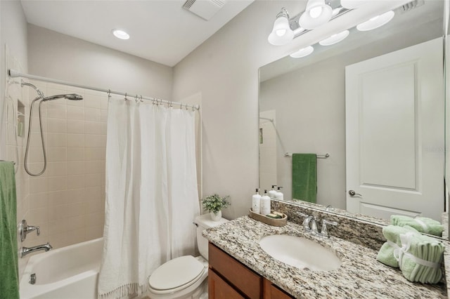 full bathroom with vanity, shower / bath combination with curtain, and toilet