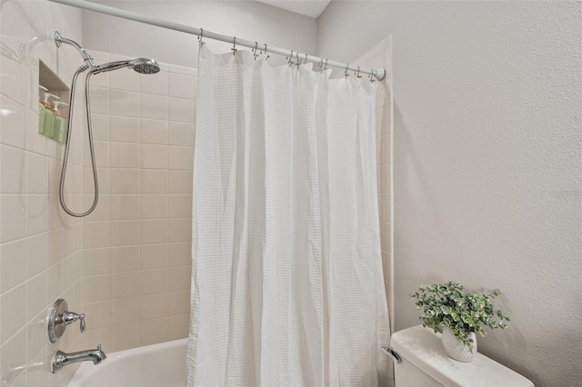 bathroom featuring shower / tub combo with curtain and toilet