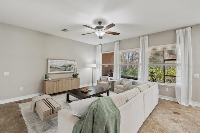 tiled living room featuring ceiling fan