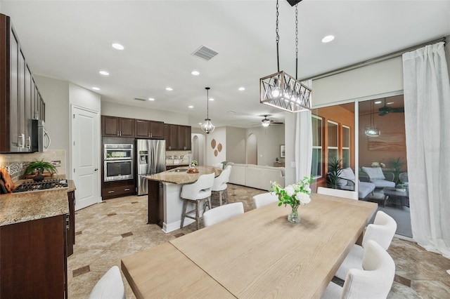 dining space with sink and ceiling fan