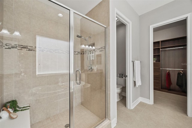 bathroom with walk in shower, tile patterned floors, and toilet