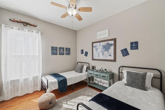 bedroom featuring hardwood / wood-style flooring and ceiling fan