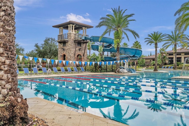 view of swimming pool with a water slide