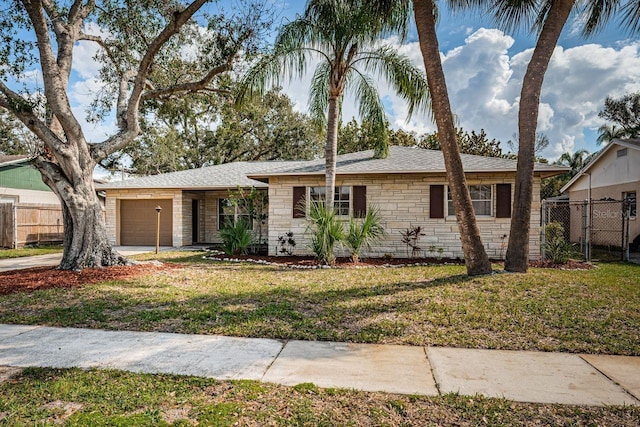 ranch-style house with a garage and a front yard