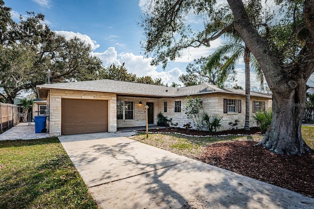 ranch-style house featuring a garage and a front yard