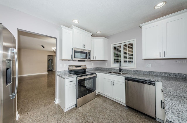 kitchen featuring white cabinetry, sink, light stone counters, and stainless steel appliances