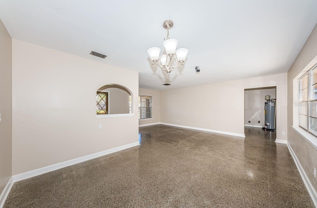 unfurnished living room featuring water heater and an inviting chandelier