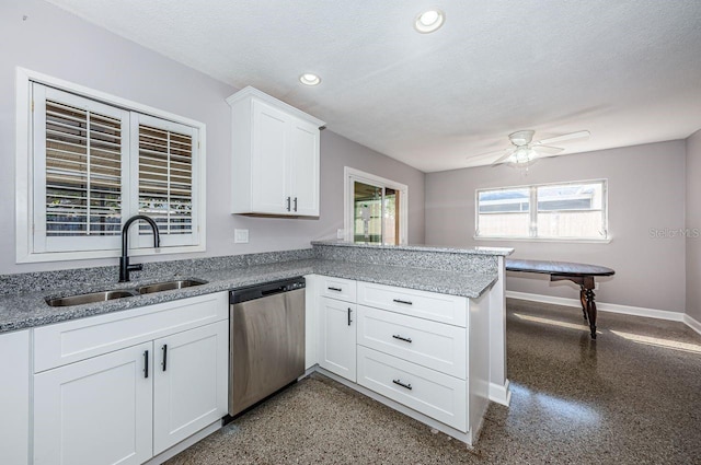 kitchen with sink, white cabinets, stainless steel dishwasher, kitchen peninsula, and a textured ceiling