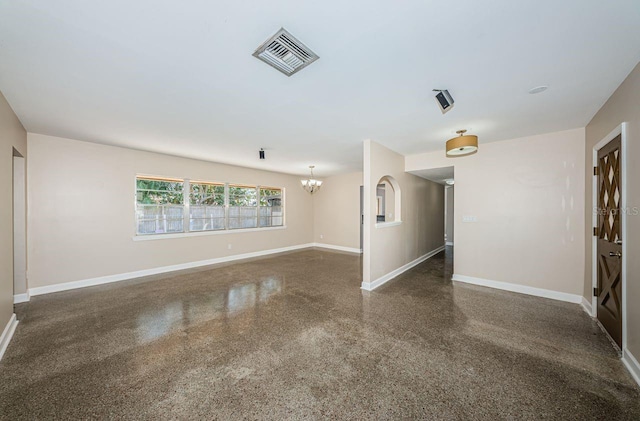 unfurnished room with an inviting chandelier