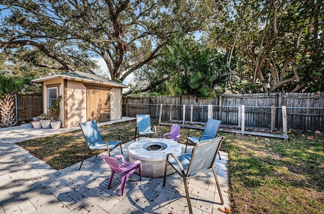 view of patio with a storage unit and a fire pit