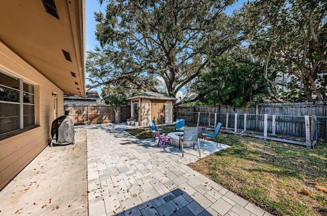 view of patio / terrace with a fire pit and a shed