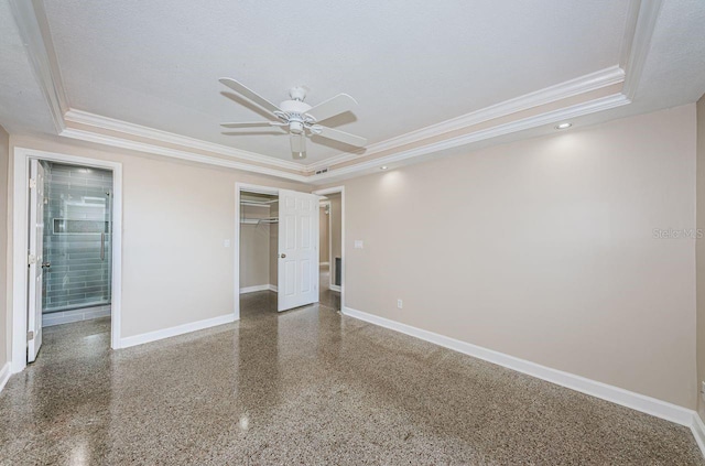 unfurnished bedroom with a raised ceiling, ornamental molding, a textured ceiling, and a closet