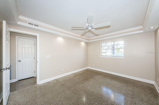 empty room with ceiling fan, ornamental molding, a raised ceiling, and a textured ceiling