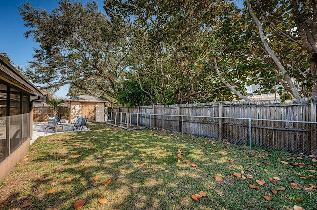 view of yard with a storage shed and a patio area