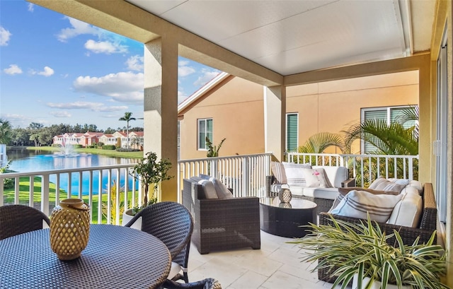 balcony with a water view and an outdoor living space