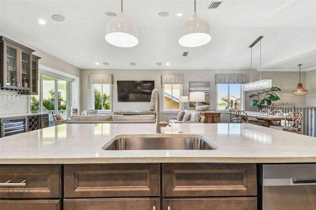 18 Franklin Ct S Unit D, Saint Petersburg, FL 33711 - kitchen featuring a sink, dishwasher, open floor plan, dark brown cabinetry, and recessed lighting