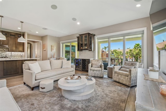 18 Franklin Ct S Unit D, Saint Petersburg, FL 33711 - living room with healthy amount of natural light, light wood-type flooring, recessed lighting, wine cooler, and a dry bar