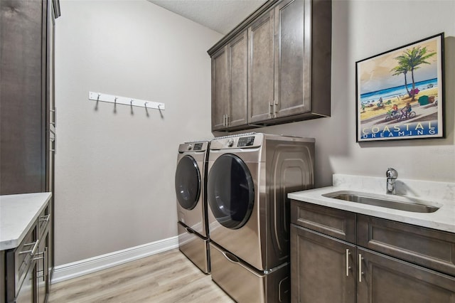 18 Franklin Ct S Unit D, Saint Petersburg, FL 33711 - washroom with washing machine and dryer, cabinet space, light wood-style flooring, and baseboards