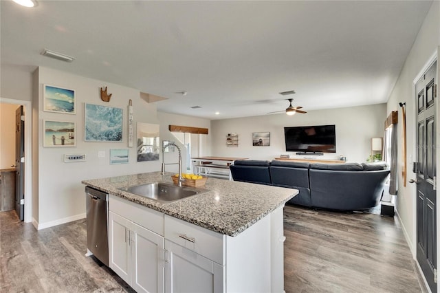 kitchen with sink, white cabinetry, light stone counters, an island with sink, and stainless steel dishwasher