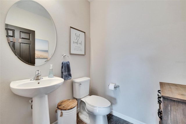 bathroom with sink, hardwood / wood-style floors, and toilet