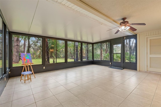 unfurnished sunroom with ceiling fan