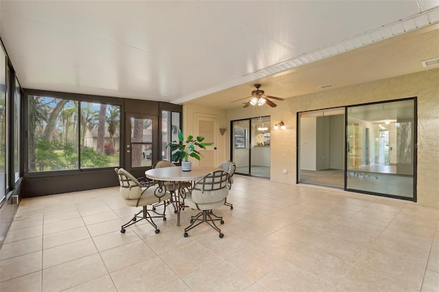 sunroom featuring ceiling fan