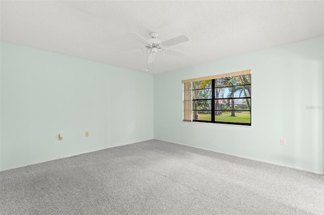 spare room with carpet floors, ceiling fan, and a textured ceiling