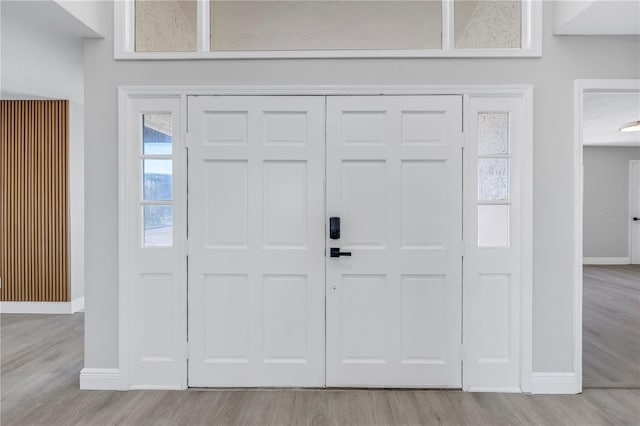 entrance foyer featuring light wood-style flooring and baseboards