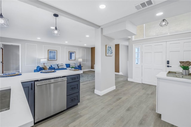 kitchen featuring light countertops, stainless steel dishwasher, visible vents, and pendant lighting