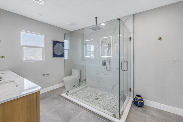 bathroom featuring toilet, a marble finish shower, baseboards, and vanity