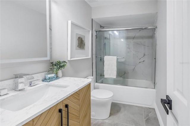 bathroom with shower / bath combination with glass door, vanity, and toilet