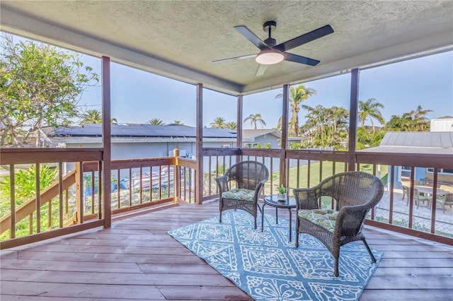 sunroom featuring ceiling fan