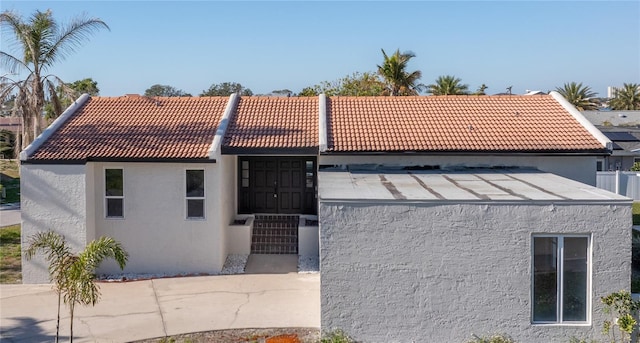 mediterranean / spanish-style house with a tiled roof and stucco siding