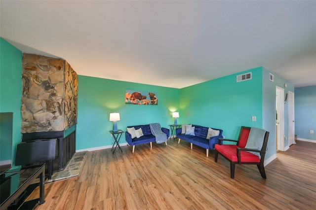 14505 Catalina Cir, Seminole, FL 33776 - living room featuring a fireplace and hardwood / wood-style floors