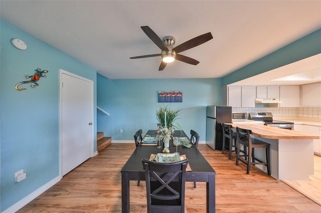 14505 Catalina Cir, Seminole, FL 33776 - dining area featuring ceiling fan and light wood-type flooring