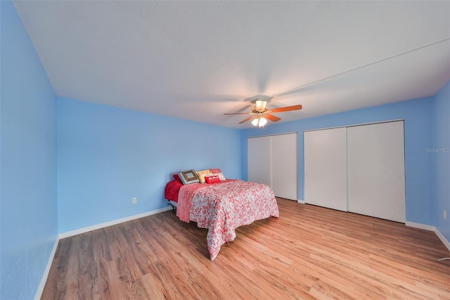 14505 Catalina Cir, Seminole, FL 33776 - bedroom featuring multiple closets, ceiling fan, and light hardwood / wood-style floors
